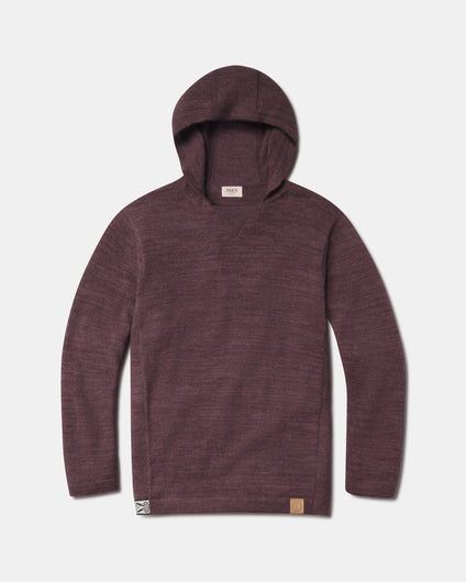 Front view of The Hoodie alpaca wool pullover with hood in raisin, showing knit texture and front hem logo on white background