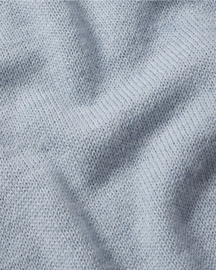 Close-up of The Original Crew alpaca crewneck in sky blue showing soft knit texture and alpaca fiber