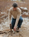 Man Splitting Wood Outdoors in The Hoodie Pebble / Beige Alpaca Sweater with a Hood – PAKA Apparel