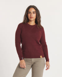 Front view of The Lightweight Crew alpaca crewneck in burgundy showing V stitch neckline and leather logo patch on white