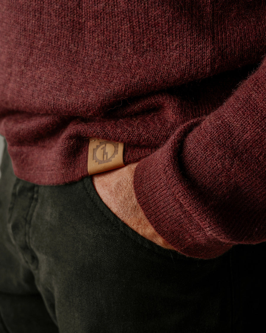 Close-Up of Leather PAKA Logo on Waist of The Original Crew Burgundy Alpaca Sweater Worn Over Dark Pants – PAKA Apparel