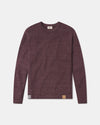 Front view of The Original Crew alpaca sweater in raisin showing raglan sleeves and leather hem patch on gray background