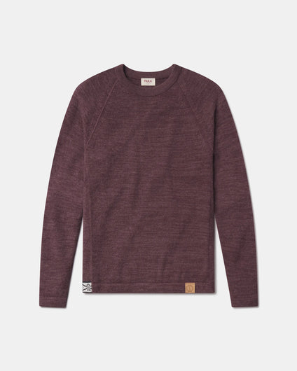 Front view of The Original Crew alpaca sweater in raisin showing raglan sleeves and leather hem patch on gray background