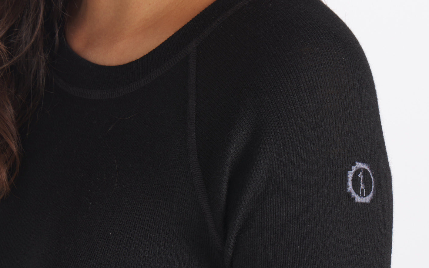 Close-up of Men’s 1.0 thermal baselayer showing rib-knit texture, flatlock seam and small embroidered logo on white background