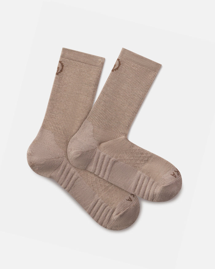 Top-down view of tan Trail 3/4 crew socks showing ribbed cuffs, cushioned soles and arch support on white background