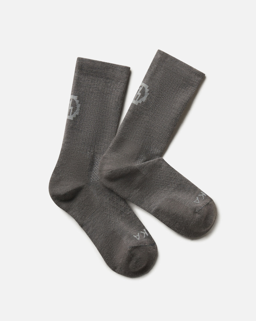 Flat lay of Trail Crew Socks in dark gray showing crew height, cushioned footbed and PAKA logo on white background