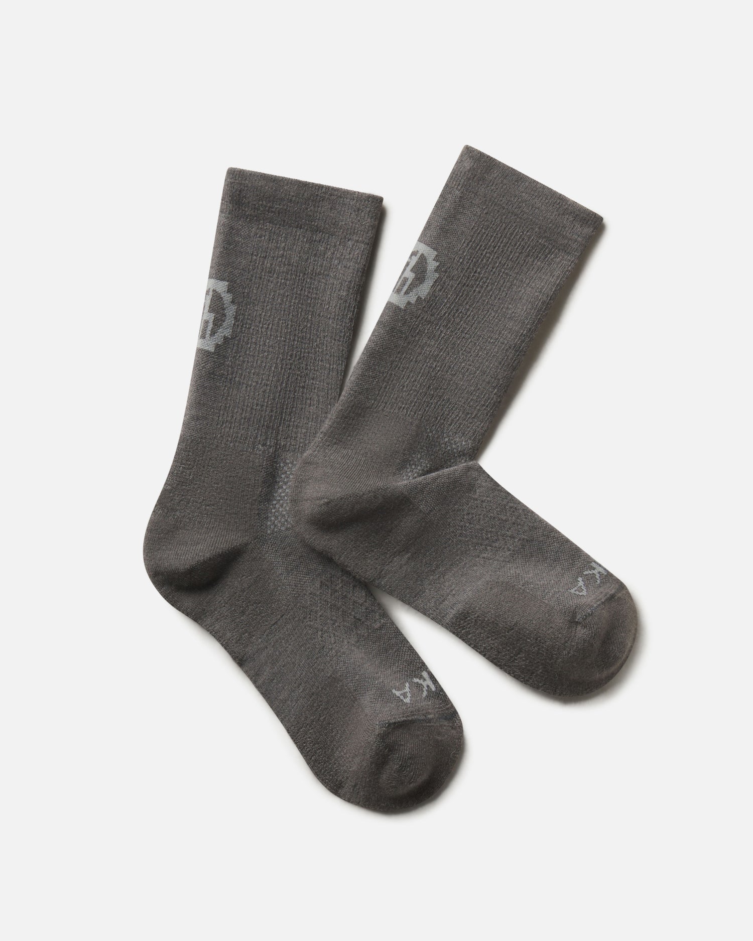 Flat lay of Trail Crew Socks in dark gray showing crew height, cushioned footbed and PAKA logo on white background