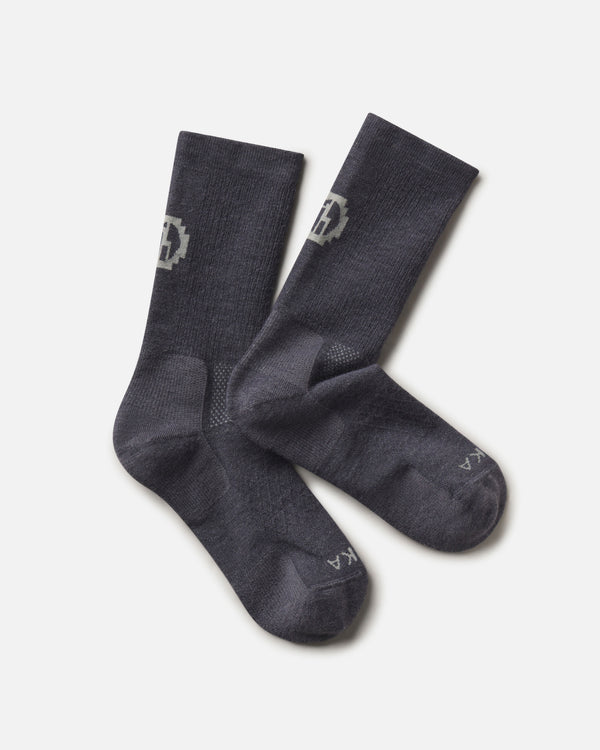 Top-down view of Trail Crew Socks showcasing charcoal blue color, crew height, cushioned footbed and PAKA logo on white background