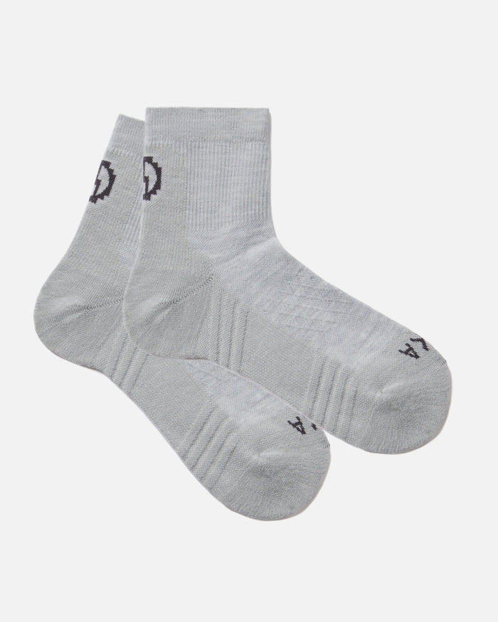 Angled flat lay of Trail 1/4 crew socks, light gray, showing ankle height and cushioned sole on white background