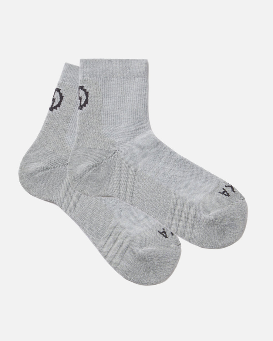 Angled flat lay of Trail 1/4 crew socks, light gray, showing ankle height and cushioned sole on white background