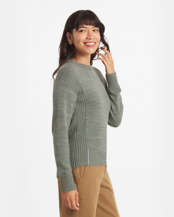 Side view of Women’s Original Crew alpaca crewneck showing ribbed side panels and cuffs on a model against a white background
