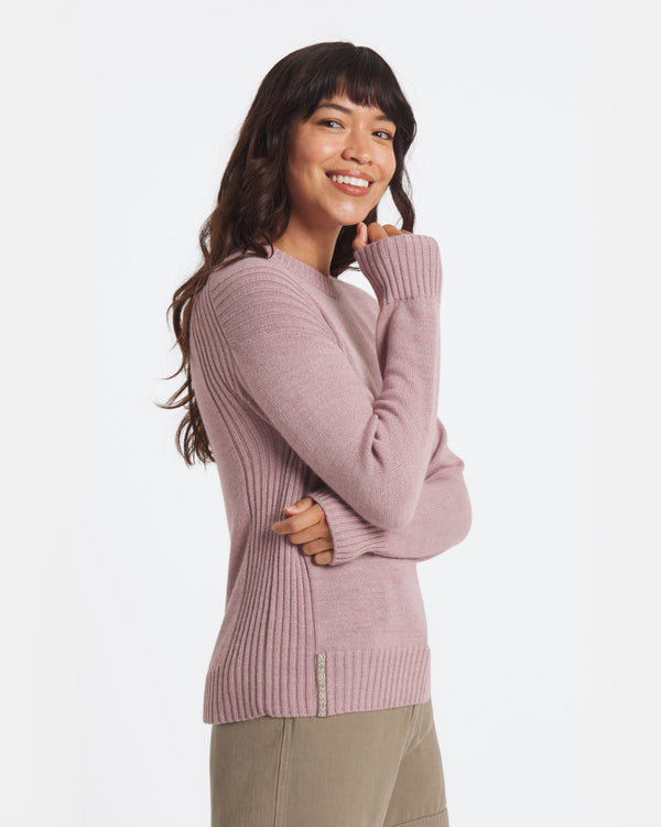 Woman wearing a pink sweater on a white background