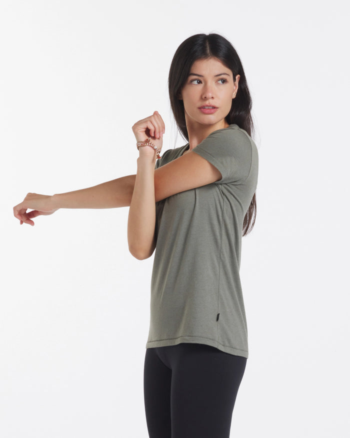 Side view of Women’s Essential V-neck t-shirt on model showcasing V-neck, short sleeves, and regular fit against white background