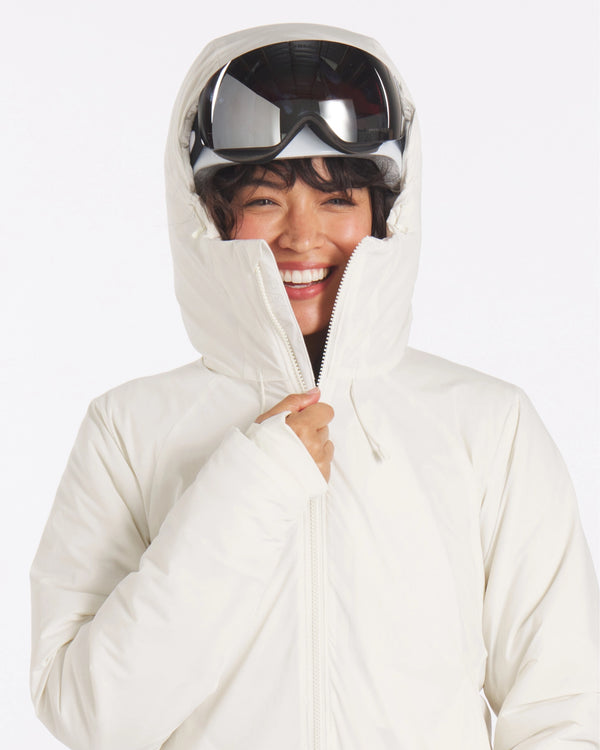 Front view of The Original Women’s Apu Parka in ivory, hood up showing high padded collar and full-length zipper