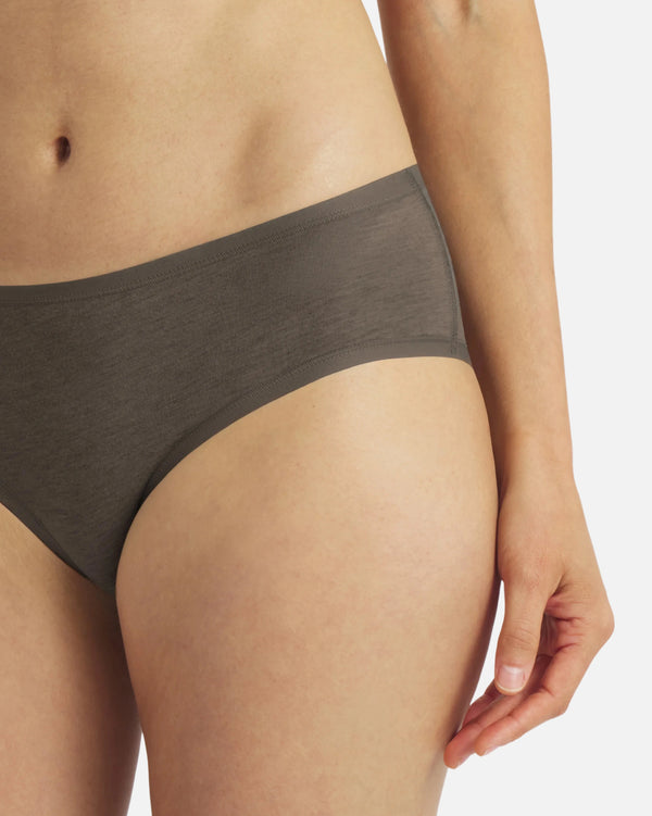 Front-right close-up of Women’s Essential Mid-Rise Brief in Forage (olive) on model, showcasing mid-rise coverage and smooth waistband on a light gray background