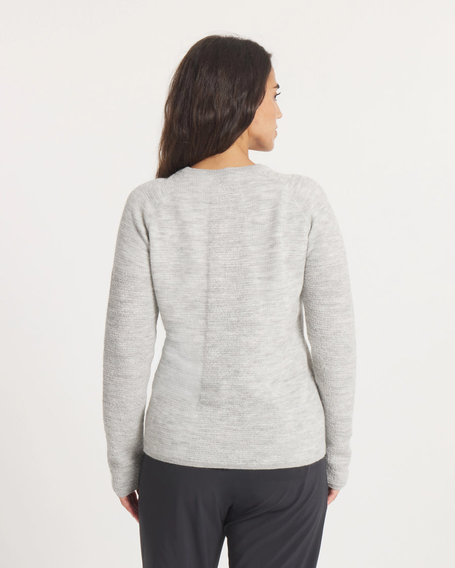 Woman wearing the Women's Mountain Crew Sweater in Light Grey  on a white background