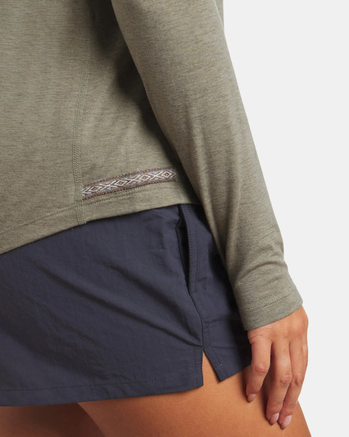 Side close-up of Women’s Sol Crew long sleeve sun shirt in elm showing patterned side hem and slim fit on model