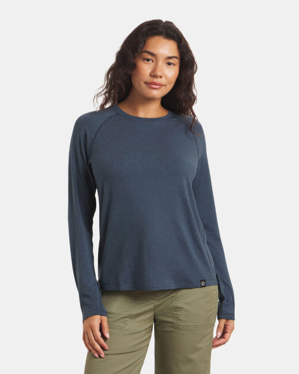 Front view of Women’s Sol Crew sun-protection shirt in navy on model, relaxed fit with crew neckline and raglan sleeves