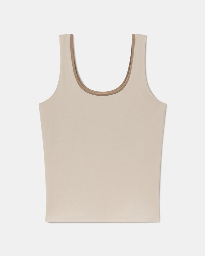 Flat lay of Women’s Essential Tank showing scoop neckline and built-in shelf bra in birch on white background