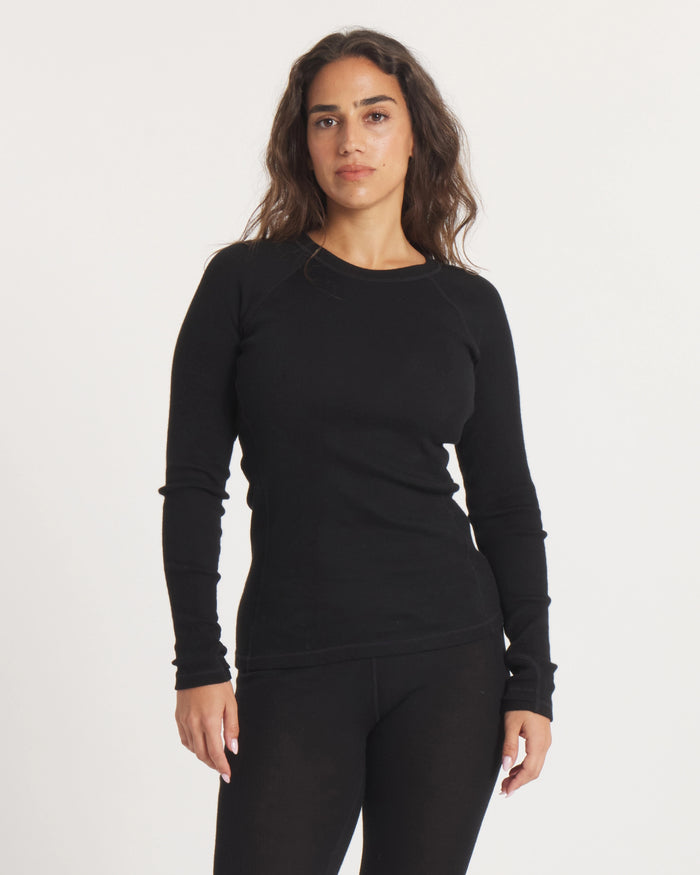 Front view of Women’s Thermal Crew alpaca baselayer in black, slim fit with long sleeves on white background