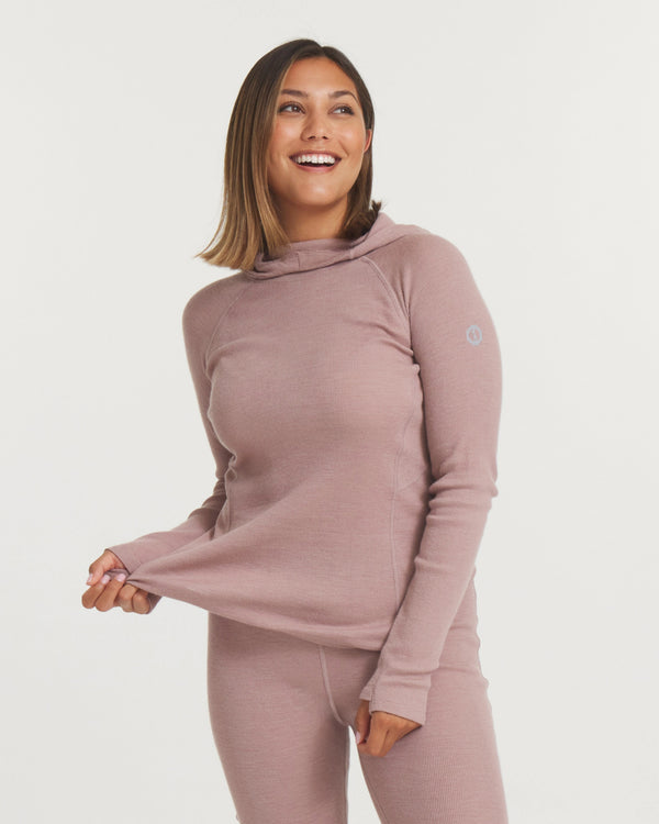 Front three-quarter view of Women’s Thermal Hoodie in magnolia pink on model, fitted with thumbhole cuffs and hood, white background