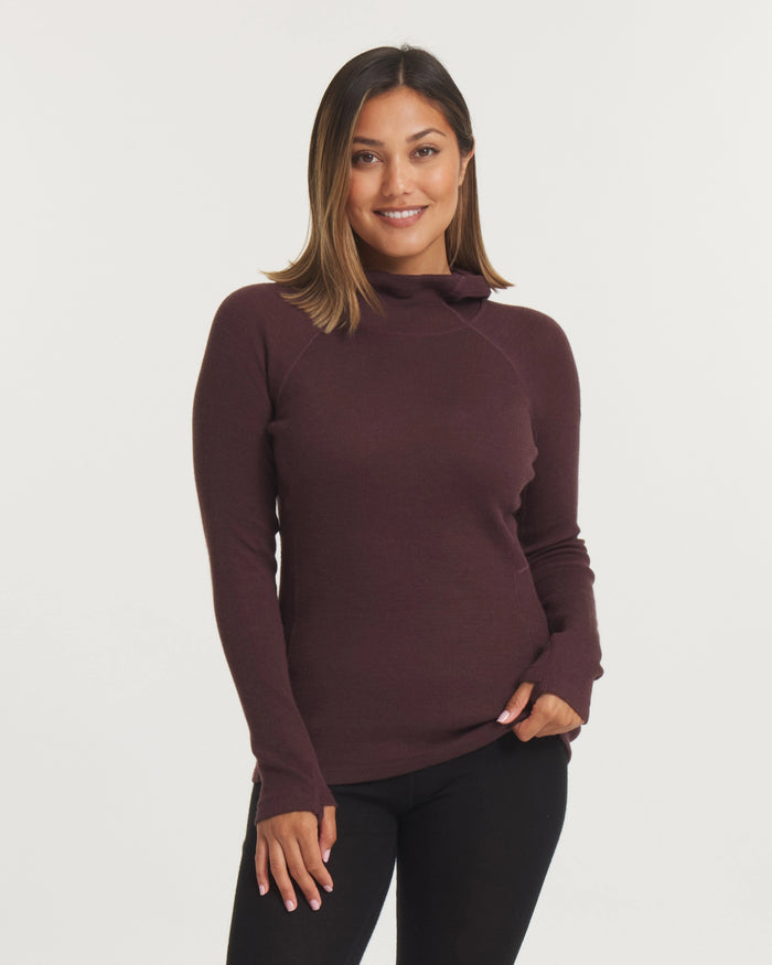 Front view of Women’s Thermal Hoodie in uva plum on model showcasing slim fit, mock neck and thumbhole sleeves