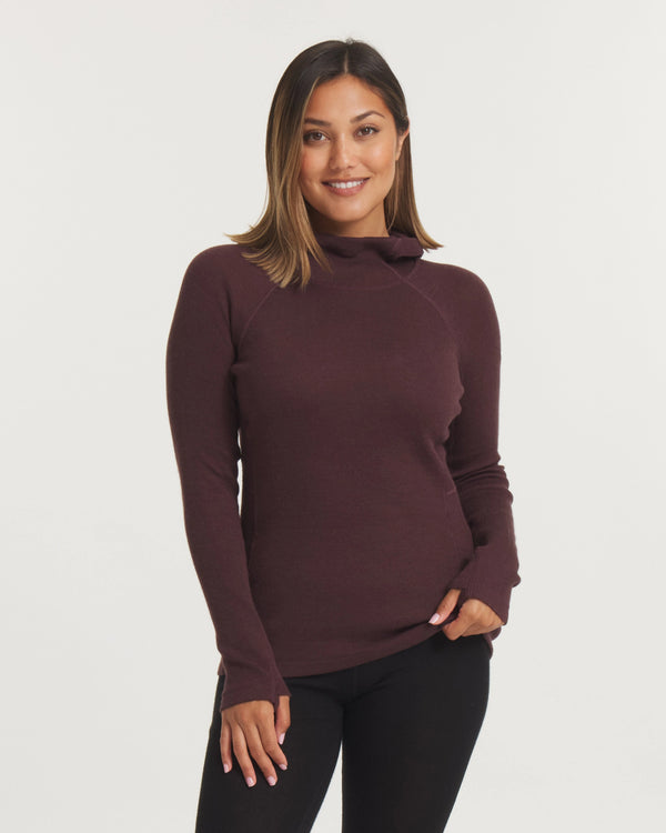 Front view of Women’s Thermal Hoodie in uva plum on model showcasing slim fit, mock neck and thumbhole sleeves