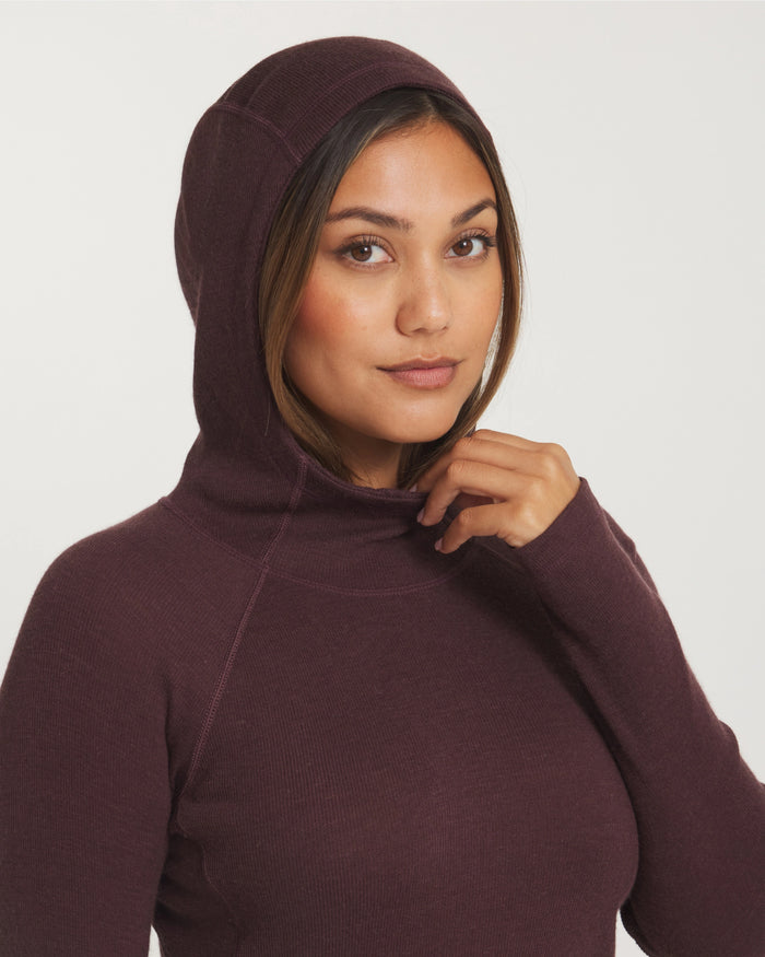 Close-Up of Model with Hood Up and Hand on Neckline of Women's Thermal Hoodie in Uva / Dark Purple – PAKA Apparel