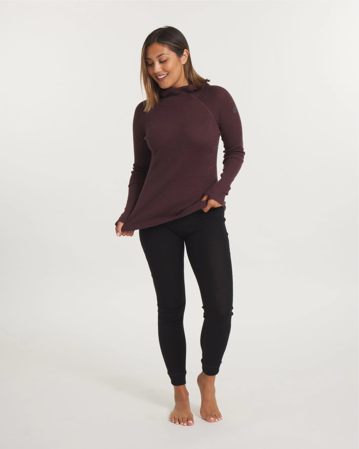 Three-quarter front of Women’s Thermal Hoodie in burgundy on a model showing hood, fitted shape and thumbhole cuffs