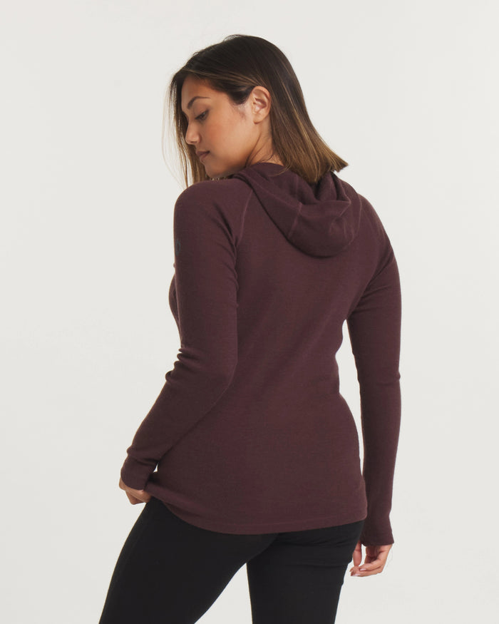 Back view of Women’s Thermal Hoodie in plum showing fitted silhouette and hood on model against light background