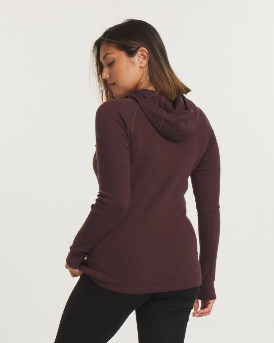 Back view of Women’s Thermal Hoodie in plum showing fitted silhouette and hood on model against light background