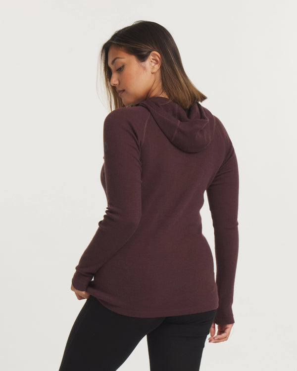 Back view of Women’s Thermal Hoodie in plum showing fitted silhouette and hood on model against light background