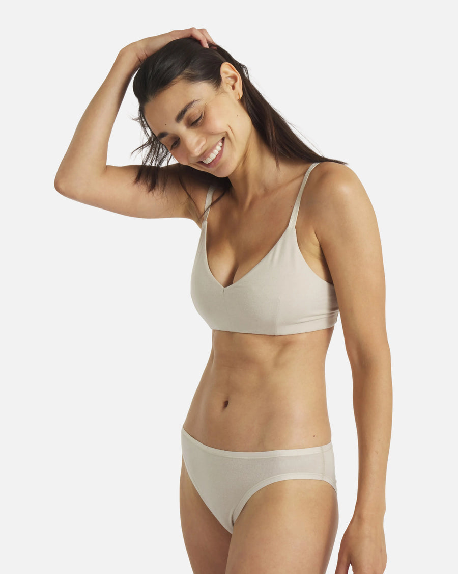 Angled front view of Women’s Essential Triangle Bralette in Birch on model showing deep V wireless padless cups, Inca straps