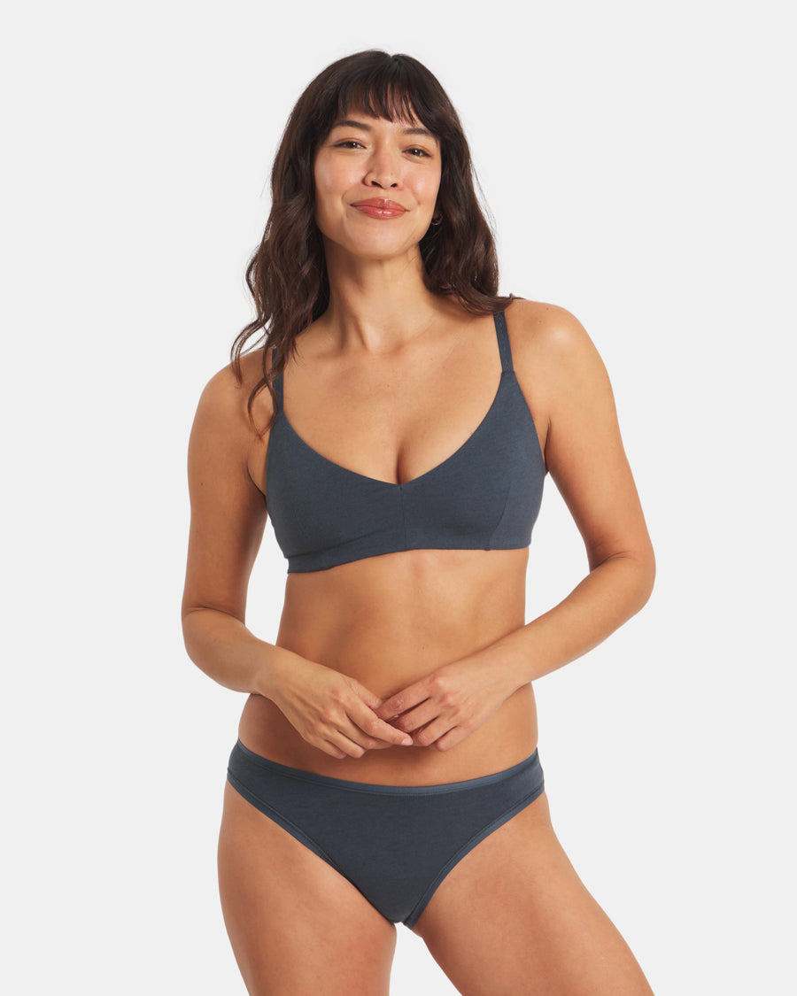 Front view of Women’s Essential Triangle Bralette in navy on model showing deep V triangle cups, wireless padless fit, and embossed Inca-pattern straps on white background