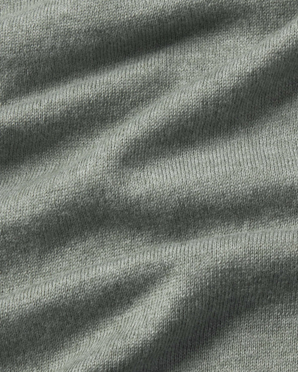 Close-up of textured green fabric with folds