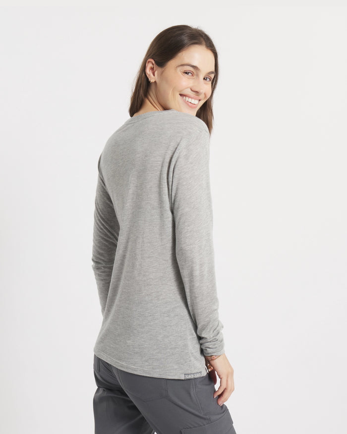 Back view of Women’s Aire Long Sleeve shirt in heather grey, slim lightweight fit on model, white background