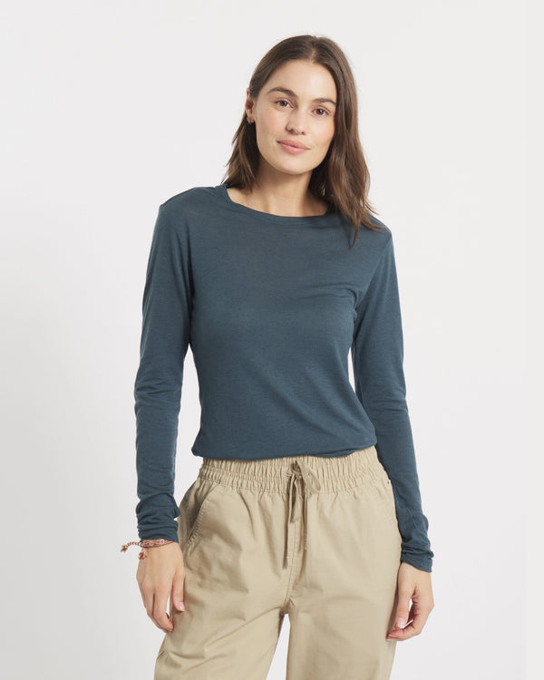 Front view of Women’s Aire Long Sleeve shirt showcasing slim fit, long sleeves in navy on model with white background