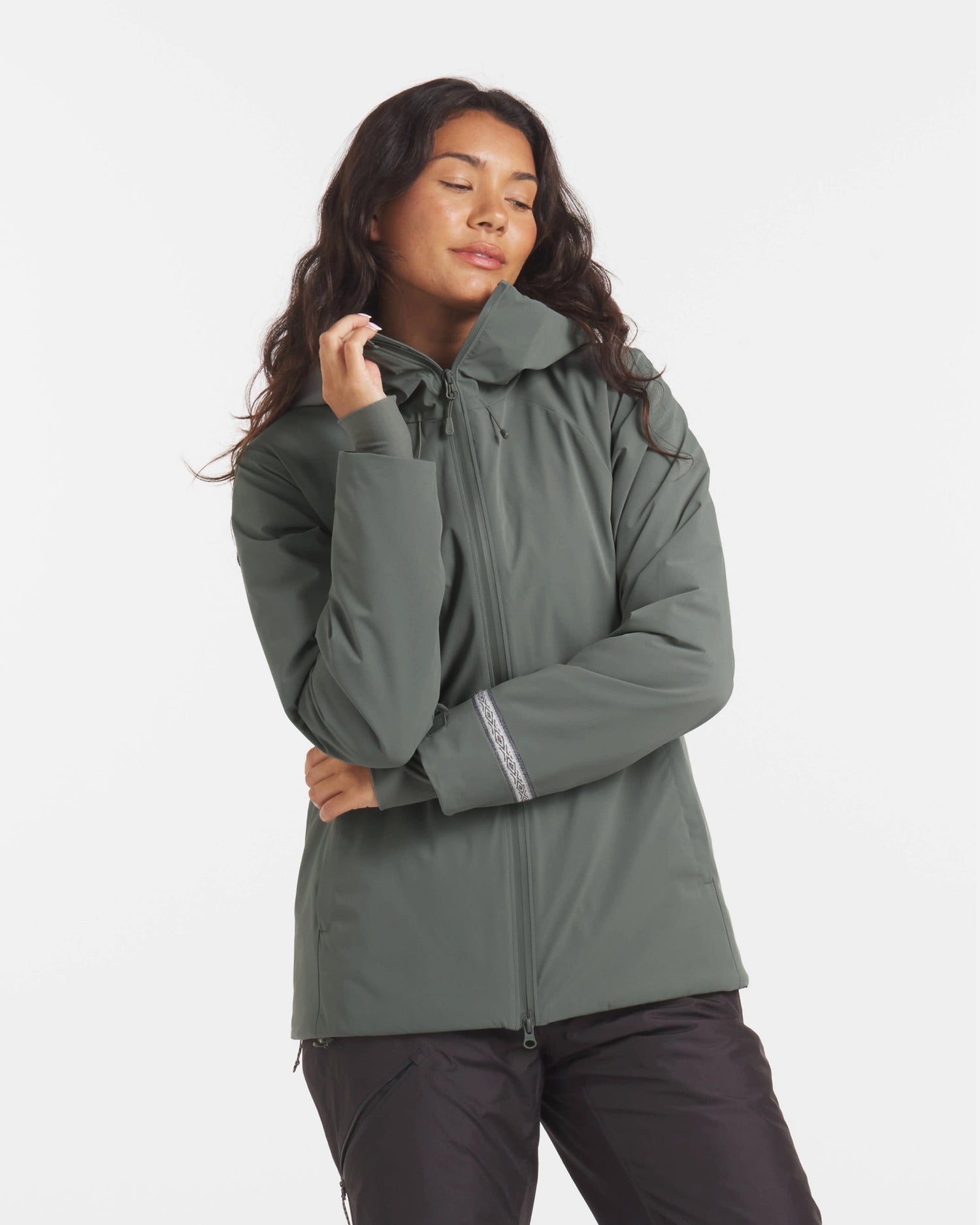 Three-quarter front of Women’s Apu Parka in eucalyptus on model showing hood, zip front, and relaxed fit on light background