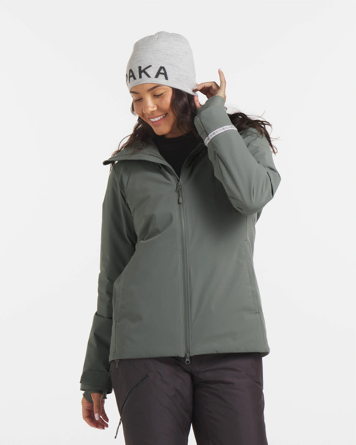 Three-quarter front view of Women’s Apu Parka in eucalyptus showcasing helmet-compatible hood, two-way front zipper, and adjustable cuffs on white background