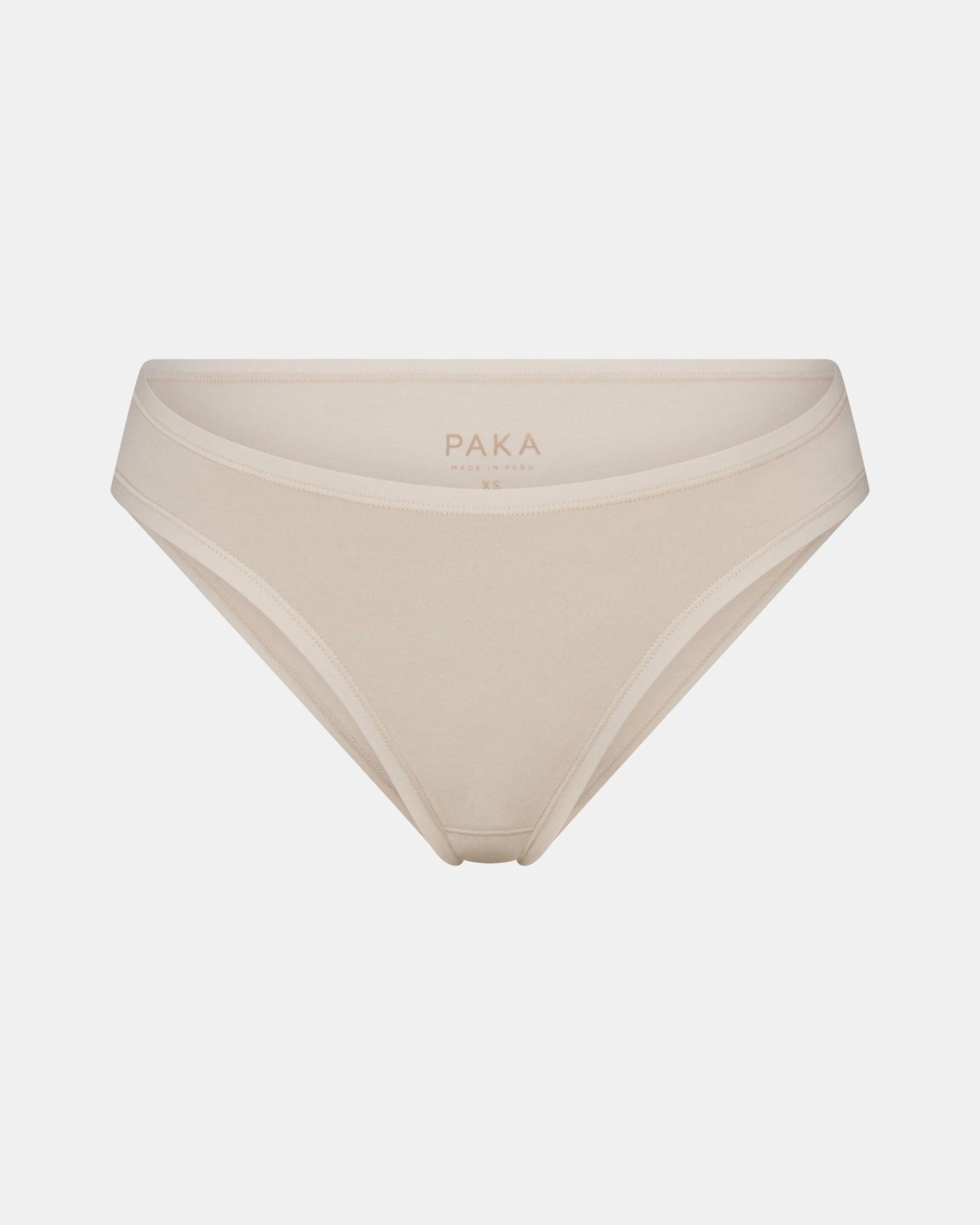 Front view of Women’s Essential Bikini Brief in Bone showing mid-rise cut, elastic trim, and interior PAKA logo on light gray background
