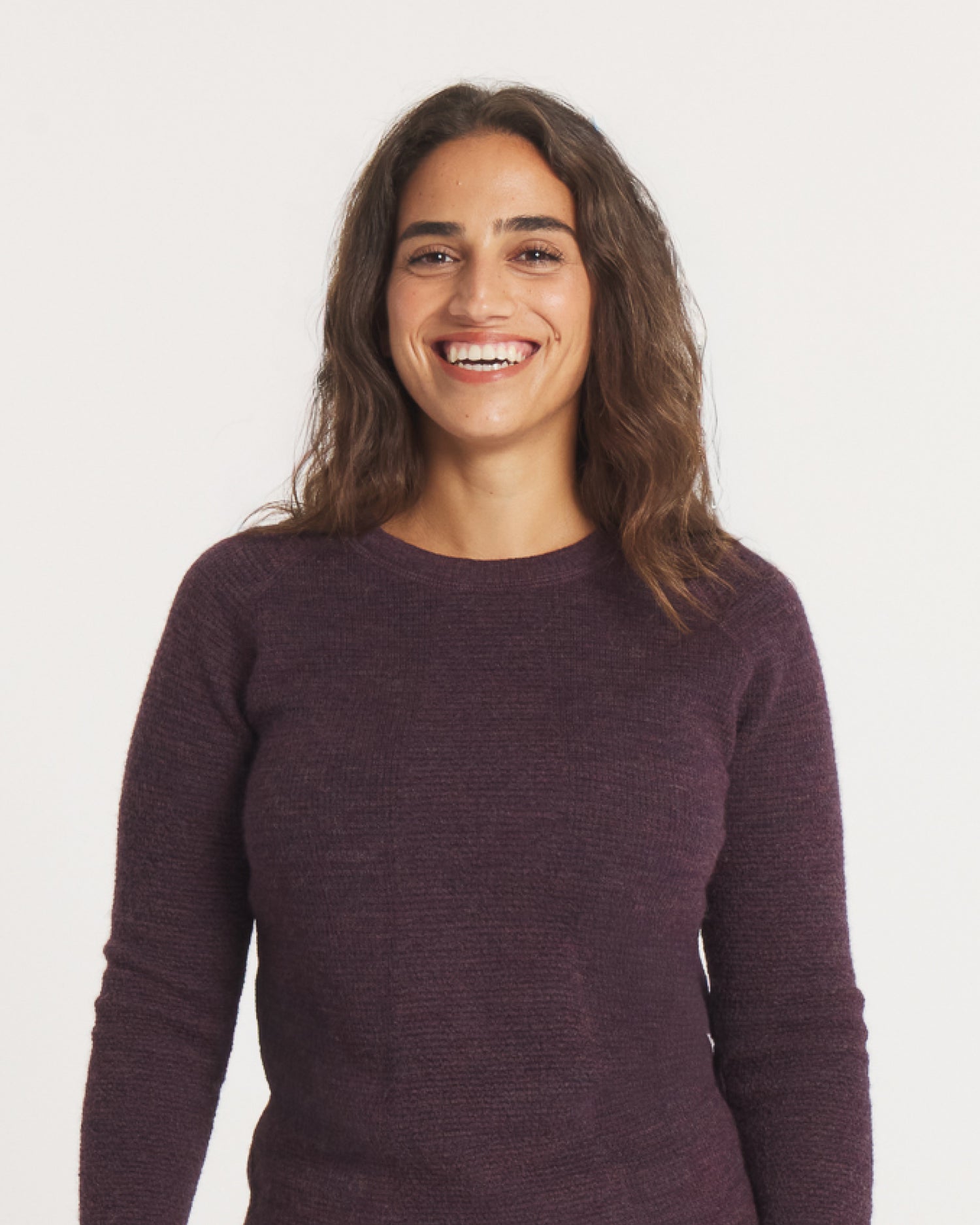 Model Smiling in Women’s Mountain Crew Alpaca Natural Fiber Outdoor Sweater in Eggplant / Purple – PAKA Apparel
