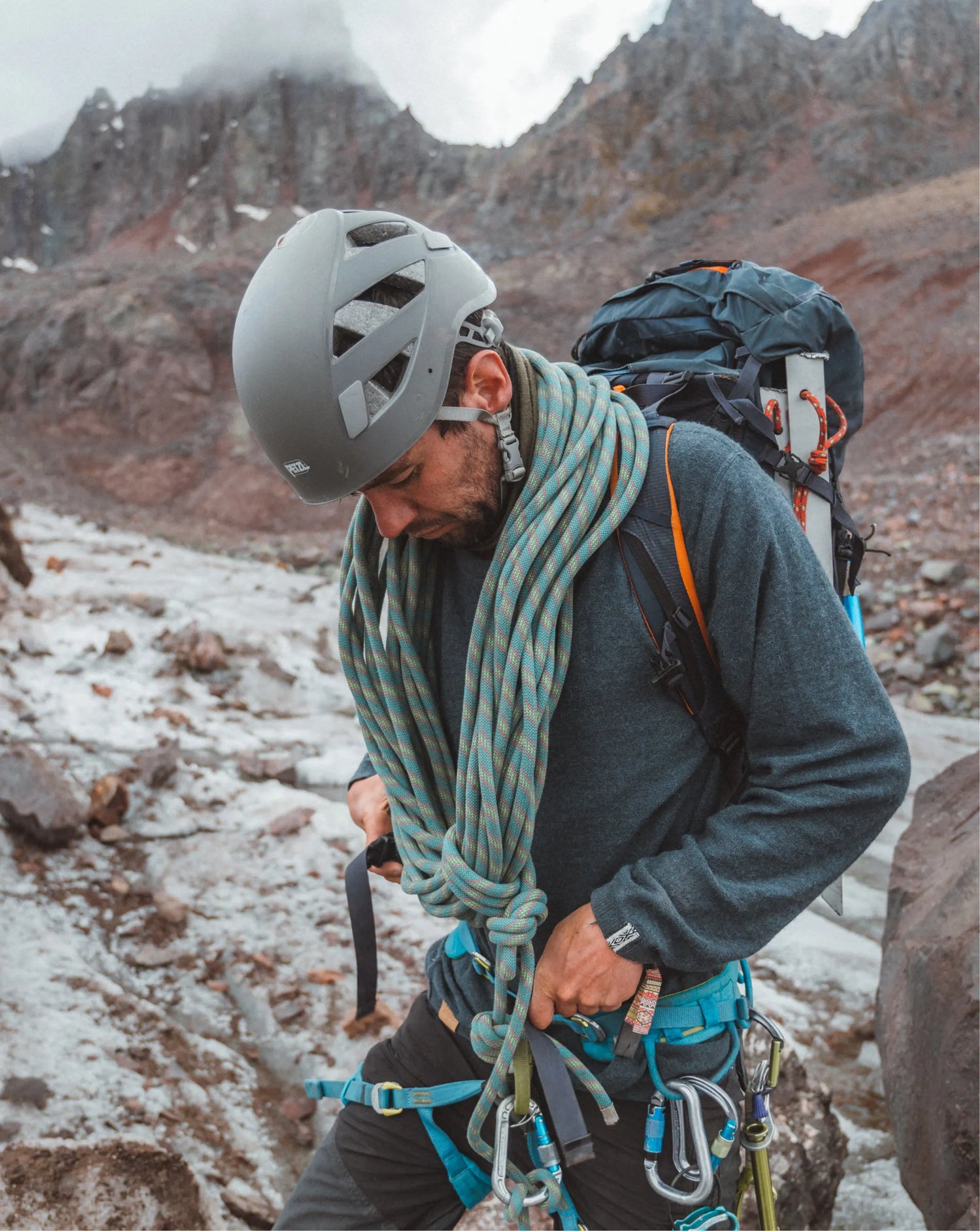 Man in blue Alpaca sweater climbing