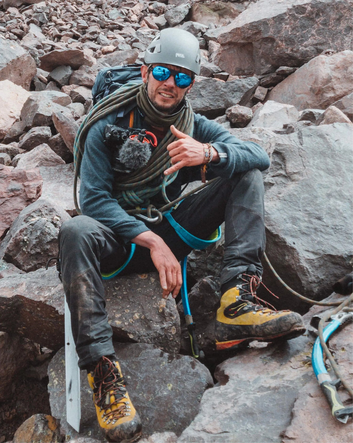 Man in blue alpaca sweater climbing