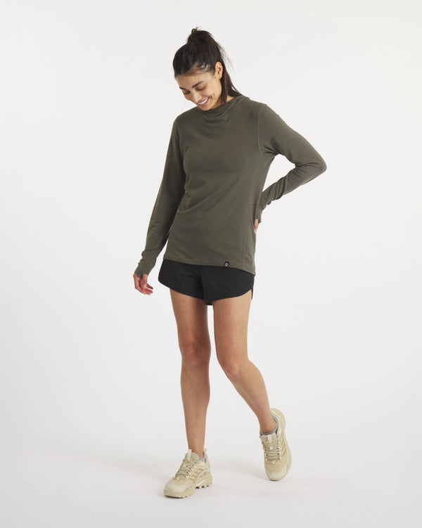 Model Looking Down with Hand on Side in Sol Women's Sun Hoodie in Andean Moss / Dark Green – PAKA Apparel
