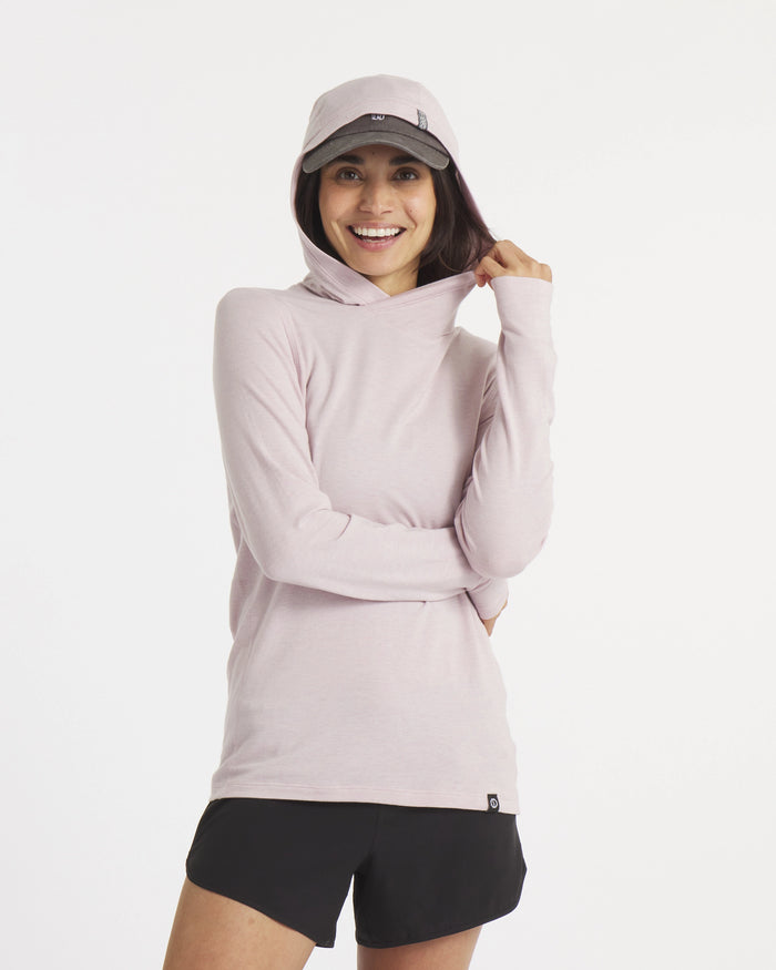 Front view of Women’s Sol Hoodie in lilac on model, hood up showing cross-over hood and hidden thumbhole, white background