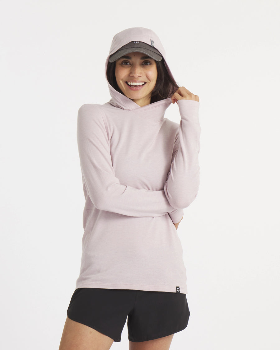 Front view of Women’s Sol Hoodie in lilac on model, hood up showing cross-over hood and hidden thumbhole, white background