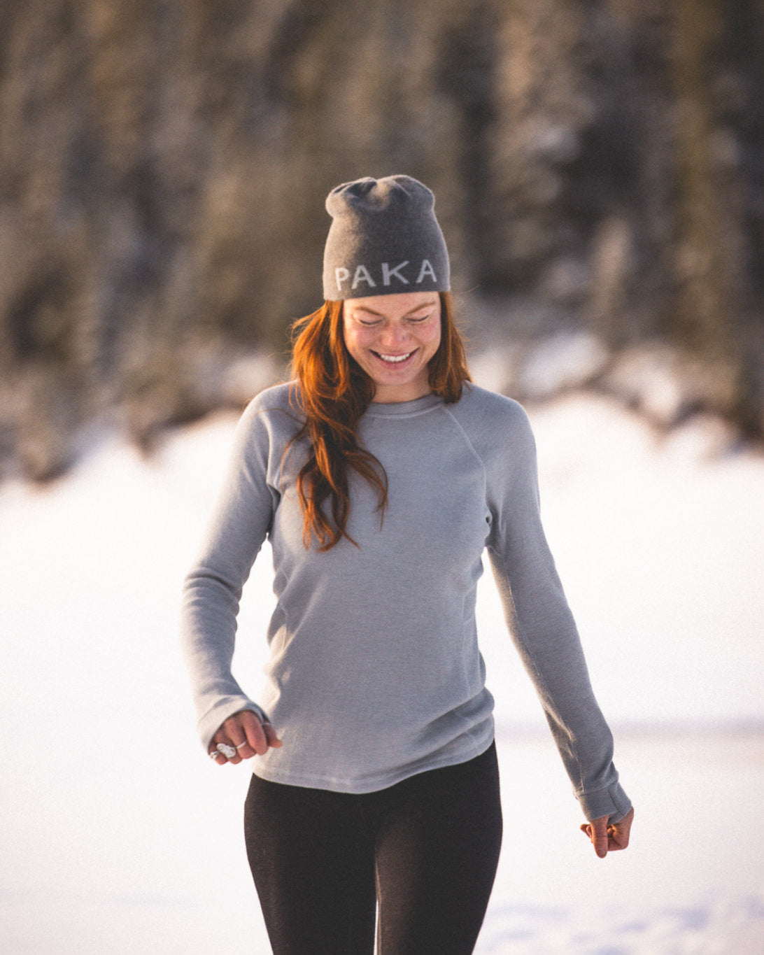 Woman Named Casey Walking Through Snow in Beanie and Silver / Light Grey Alpaca Wool Thermal Baselayer Longsleeve Shirt – PAKA Apparel