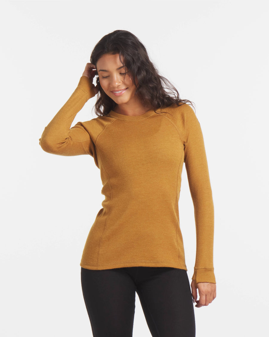 Front view of Women’s 1.0 Thermal Crew in golden yellow showcasing crew neck, long sleeves, rib-knit texture and roomier fitted silhouette on white background