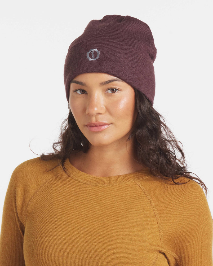 Woman in Beanie Wearing Golden Brown Moisture-Wicking Alpaca Wool Thermal Baselayer Shirt – PAKA Apparel