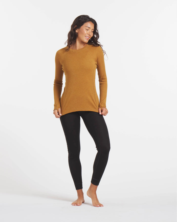 Full-length view of Women’s 1.0 Thermal Crew in golden yellow on model showing long-sleeve rib knit and roomier fit